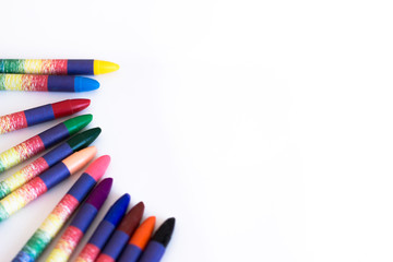 Colored wax pencils on a white background close-up