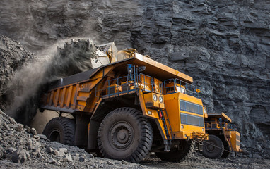 mining truck in a coal mine loading coal - obrazy, fototapety, plakaty