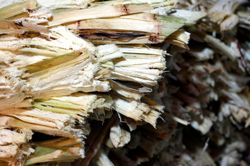 residue from sugar cane juice and rest from the juice of sweet water was removed, waste of sugarcane residue from sugar cane make drink, residual sugar cane residue in market night (selective focus)