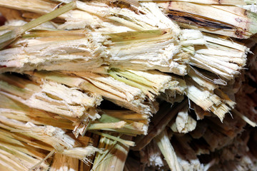 residue from sugar cane juice and rest from the juice of sweet water was removed, waste of sugarcane residue from sugar cane make drink, residual sugar cane residue in market night (selective focus)