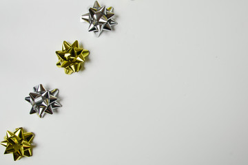 gold and silver bows on white background