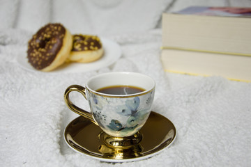 cup of coffee and cookies with books