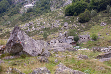 Swiss Alps with Gras and Rocks during Cloudy Day