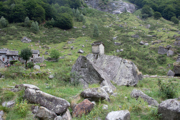 Swiss Alps with Gras and Rocks during Cloudy Day