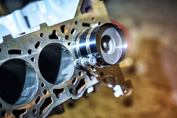 Automotive four-cylinder engine water cooling during repair.