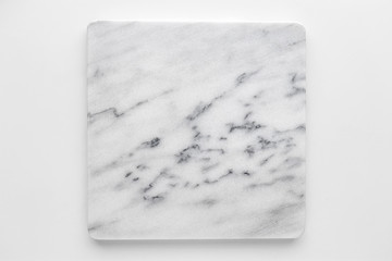 Square white marble cutting board on a white background, light gray marble stone texture background