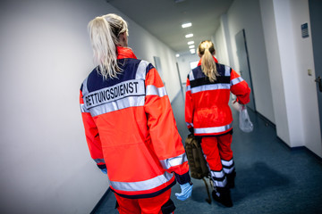 German paramedic runs in a floor to an accident