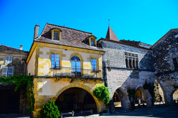 Fototapeta na wymiar Architecture in the central square of the medieval bastide village of Monpazier in the Dordogne region of France