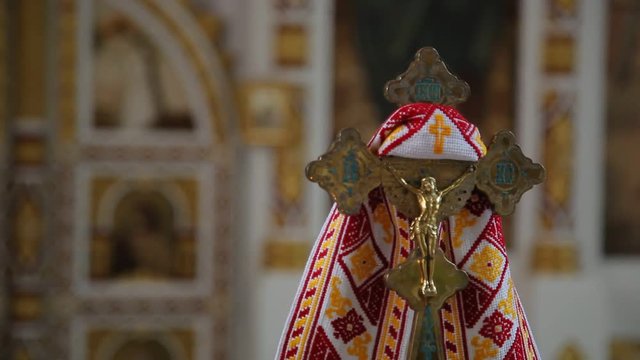 Kiev, Ukraine - November 13, 2018: refocus from wall to big metal christian cross with Jesus in the orthodox church