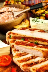 Grilled pork chop on a wooden board. Protein food. Grilled meat. Food preparation. Protein diet.