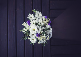 Fototapeta na wymiar beautiful wedding bouquet on wooden background. the view from the top