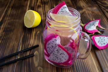 Detox water with dragon fruit and lemon on the  brown wooden  background