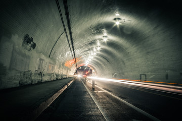 Cars speeding inside a tunnel