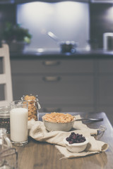 cornflakes cereal and milk in a glass. Morning tasty breakfast concept in the kitchen