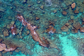 Fototapeta na wymiar Top view of the sea with corals . Rocky seashore, top view from drone
