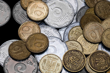 Ukrainian coins isolated on black background. Close-up view. Coins are located at the right side of frame. A conceptual image.