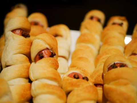 Tanned wiener sausages in pizza dough with eyes made of cloves for halloween 2