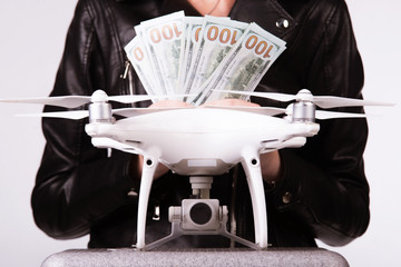 Aerial drone is on the case. Female hands hold money against his background