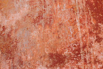 Texture of crumbling orange stucco. Wall of old building.