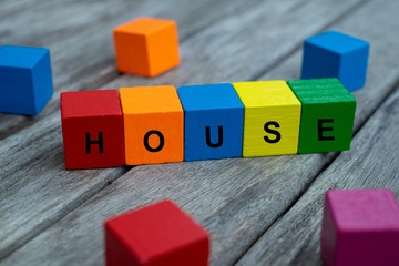 colored wooden cubes with letters. the word house is displayed, abstract illustration