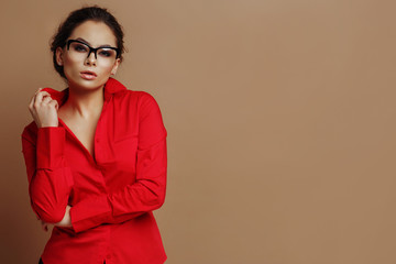 Young beautiful woman in a red shirt and sunglasses