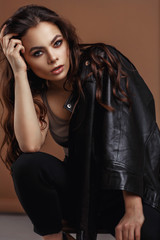 Fototapeta premium Young beautiful woman in a black jacket