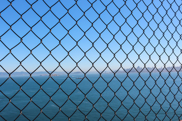 wire mesh and background, sea and city