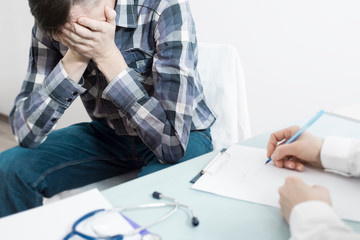 A man is sitting at the doctor's office. A doctor urologist advises the patient about prostate...