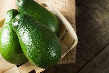 Food for vegan. Green raw frash avocado. Rustic style.