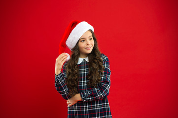 Present for Xmas. Childhood. Christmas shopping. New year party. Santa claus kid. Little girl child in santa red hat. Happy winter holidays. Small girl. Our traditions. I love christmas