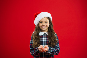 Happy winter holidays. Small girl. Little girl child in santa red hat. New year party. Santa claus kid. Present for Xmas. Childhood. Christmas shopping. sharing with close people