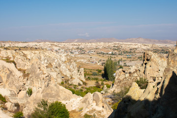 Fototapeta na wymiar Rock formations in Goreme Open Air Museum. Most popular and famous place in Cappadocia, Turkey. Sunny day, clear blue sky 