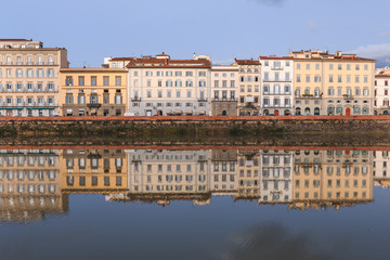 Fototapeta na wymiar Old buildings reflecting in the Arno River in Florence. Houses with reflection in water