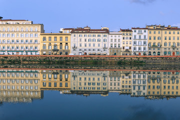Fototapeta na wymiar Old buildings reflecting in the Arno River in Florence. Houses with reflection in water