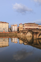 Obraz na płótnie Canvas Old buildings reflecting in the Arno River in Florence. Houses with reflection in water