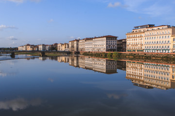 Old buildings reflecting in the Arno River in Florence. Travel destination in Italy, Europe.
