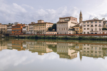 Old buildings reflecting in the Arno River in Florence. Travel destination in Italy, Europe.
