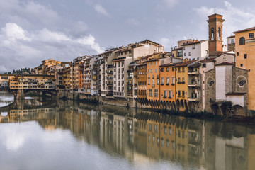 Fototapeta na wymiar Old buildings reflecting in the Arno River in Florence (Firenze). Houses with reflection in water