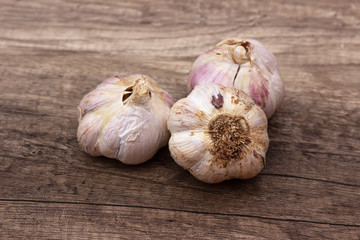 Organic garlics with cloves close up on a wooden rustic table