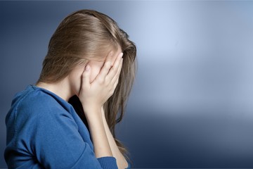 Young woman crying on background