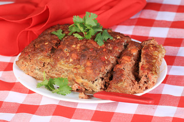 Meatloaf on Serving Platter on Red Plaid Tablecloth