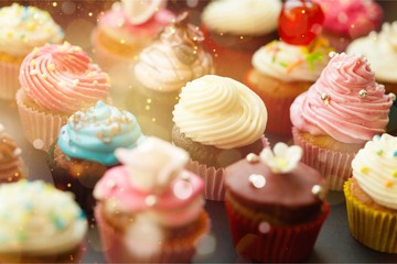 Tasty Colorful cupcakes on background