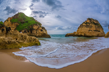 Famous rock formation in a bay on the beach of Tres Irmaos in Alvor, Portimão, Algarve, Portugal, Europe. Praia dos Tres Irmaos.