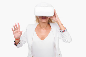 Blond woman in white suite with virtual reality goggles. Studio shot on white background