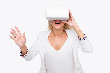 Blond woman in white suite with virtual reality goggles. Studio shot on white background