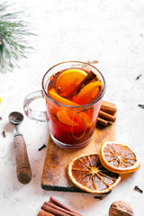 Christmas drink, mulled wine with orange, cinnamon and cloves on white background