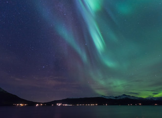 Naklejka na ściany i meble The polar arctic Northern lights aurora borealis sky star in Scandinavia Norway Tromso in the farm winter forest 