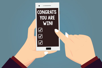 Word writing text Congrats You Are Win. Business concept for Congratulations for your accomplish competition winner Hu analysis Hands Holding Pointing Touching Smartphone Blank Color Screen