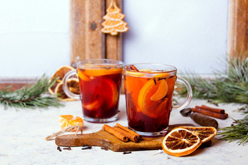 Christmas drink, mulled wine with orange, cinnamon and cloves on white background