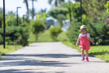 Fototapeta premium little girl runing in the summer Park